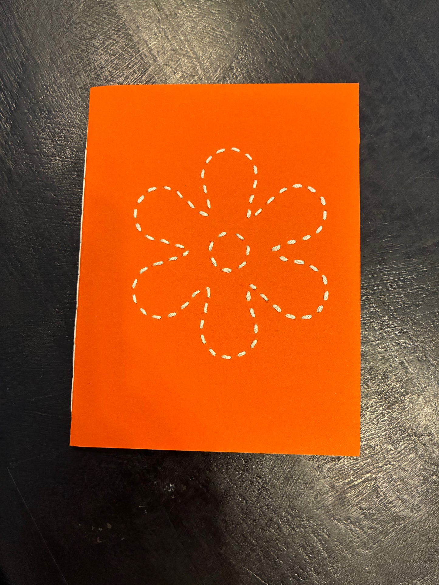 Carmen’s orange daisy notebook. Small